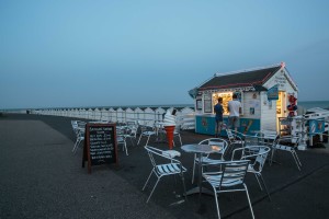 The English seaside Lights glow in an old fashioned ice cream kiosk on the Bexhill seafront at the end of a long hot summer evening