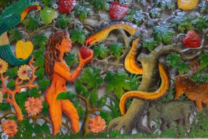 Ornaental ironwork showing Eve and the serpent and the apple on a shop wall in Tortola, BVI British Virgin Islands