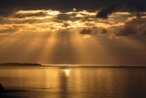 Rising sun casts a fan of golden light over the Sir Francis Drake Channel, off Tortola, British Virgin Islands