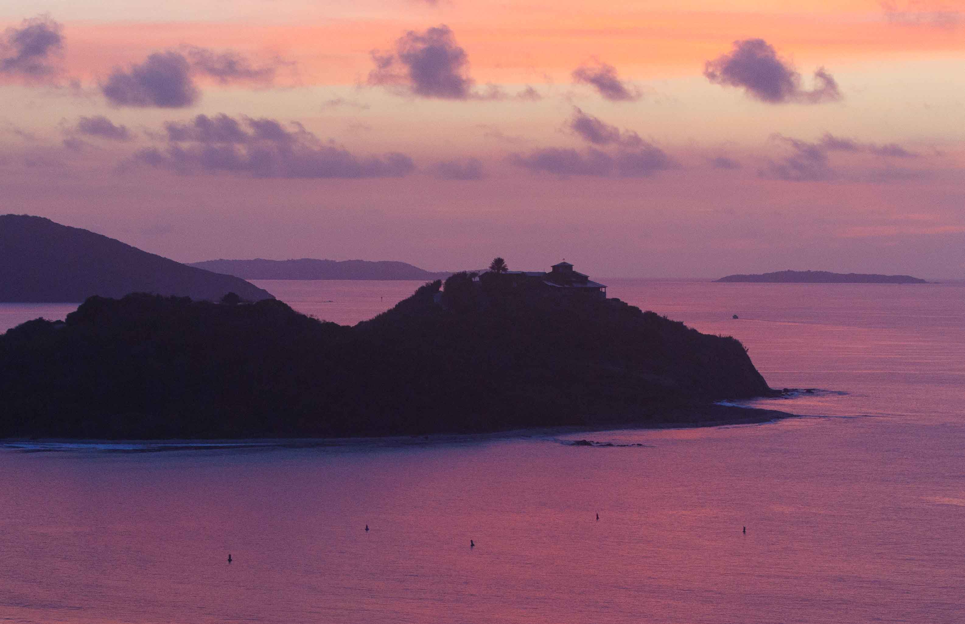 Dawn's early light casts a purple glow over the sea surrounds Buck Island just off the coast of Tortola in the British Virgin Islands - Beef Island, Virgin Gorda and Ginger Island in the background
