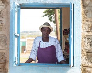 Water vendor in Naivasa, Kenya at her kiosk, part of Coca-Cola's 5by20 Project whose goal is to empower women in local communities.