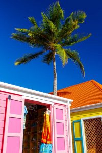 Brightly painted souvenir shacks selling T-shirts and hats and local crafts in Road Town Tortola BVI British Virgin Islands