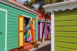 Brightly painted souvenir shacks selling T-shirts and hats and local crafts in Road Town Tortola BVI British Virgin Islands