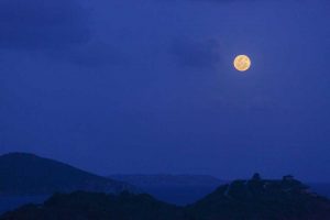 A luminous full moon rises over Virgin Gorda BVI British Virgin Islands