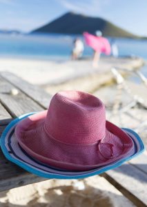 Sun hats on a beach tale at Marina Cay Tortola BVI British Virgin Islands