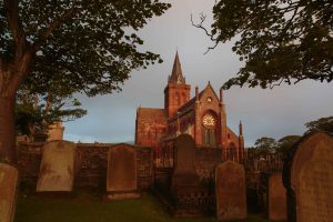 Early morning view of St Magnus cathedral and its graveyard. The Romanesque 12th century cathedral in Kirkwall is the northernmost cathedral in Britain and was built when Orkney was owned by the Norse Earls.
