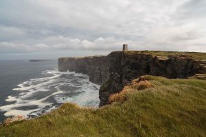 Storm tossed cliffs of Marwick Head and the monument to Lord Kitchener who lost his life off this coast in 1916 when his ship struck a German mine