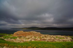 Iron Age ruins near the Broch of Gurness, Mainland Orkney, with the isle of Rousay in the background