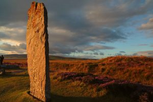 The rays of the setting sun illuminate the face of this standing stone in the 4000 year-old stone circle kown as the Ring of Brodgar, in Scotland Orkney Islands