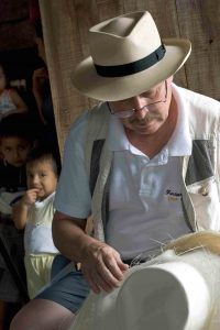 Panama Hatter Brent Black looking over hats in Pile Ecuador