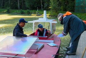 Instructors at ship handling school at Port Revel going over assignments with a harbour pilot who has come to the school to hone his skills on their scale model ships