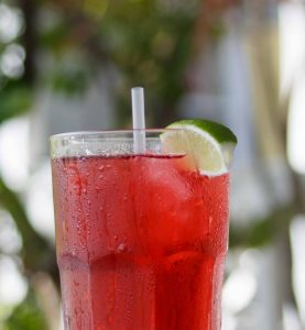 Glass of fruit flavoured iced tea with a lime slice in Road Town Tortola BVI British Virgin Islands