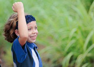 Sugar train rumbles past her family's sugar cane farm, prompting young Lucy to get the driver to blow his horn