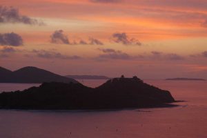 Dawn's early light casts a purple glow over the sea surrounds Buck Island just off the coast of Tortola in the British Virgin Islands - Beef Island, Virgin Gorda and Ginger Island in the background