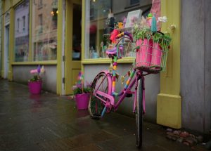 A painted-up bicycle adds a splash of colour to a rainy day streetscape on a wet Sunday afternoon in Caernarfon