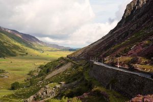 The A-5 highway snakes its way up the glacial valley of Nant Ffrancon . The road was originally laid out by Thomas Telford in the early 19th century