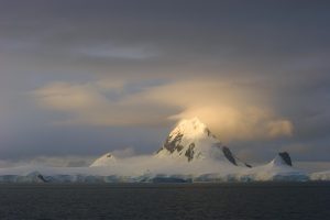 Midnight sun shimmers on the summit of a mountain on Joinville Island near the tip of the Antarctic Peninsula