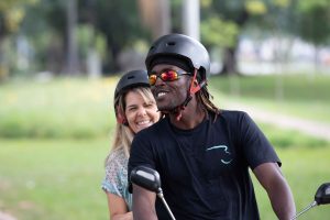 Tandem cyclists ride along a bicycle path in traffic clogged Sao Paulo Brazil