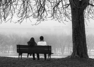 Black and white photography A couple sit on a park bench overlooking the Danube in Belgrade, Serbia