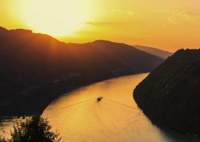 Golden light of sunset shimmers on the Danube